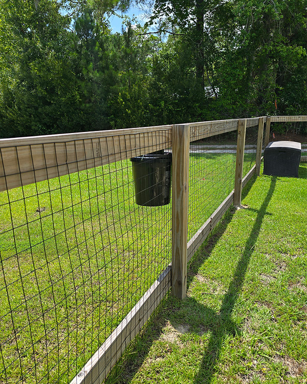 Healthy Home Outdoor Fly Defense fly trap installed along a backyard fence in Wilmington NC